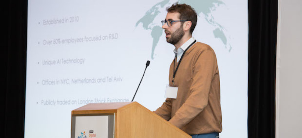 man giving a talk from a podium